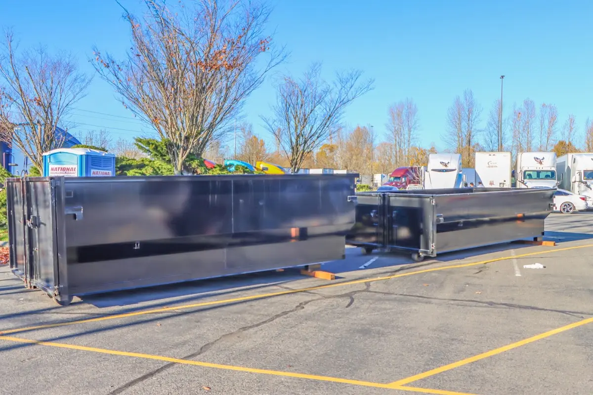 Professional dumpster rental service with roll-off container on residential driveway in Whiteland